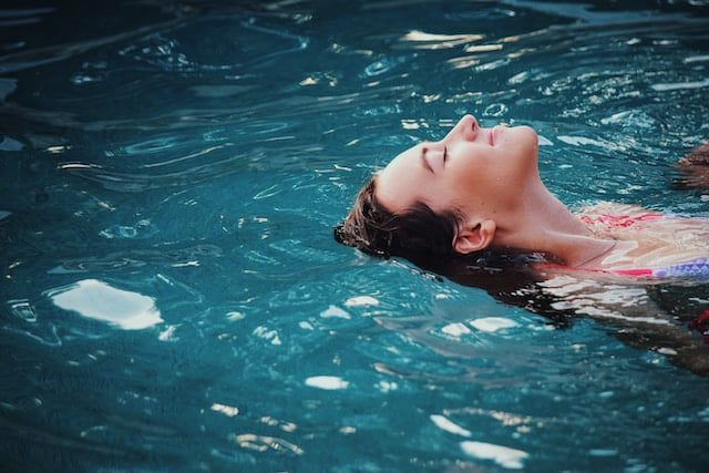 slowing down, woman floating on body of water